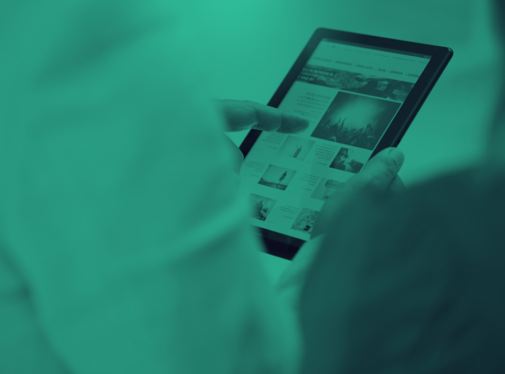 An image of a person reading a news website on a tablet